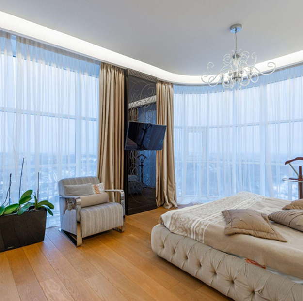 Motorized curtains in Dubai living room with smart remote control operation.