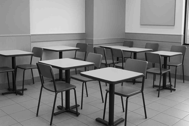 Simple fast food restaurant interior with square tables, metal chairs, and tiled flooring