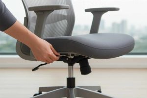 Hand adjusting the height lever of a modern ergonomic office chair.
