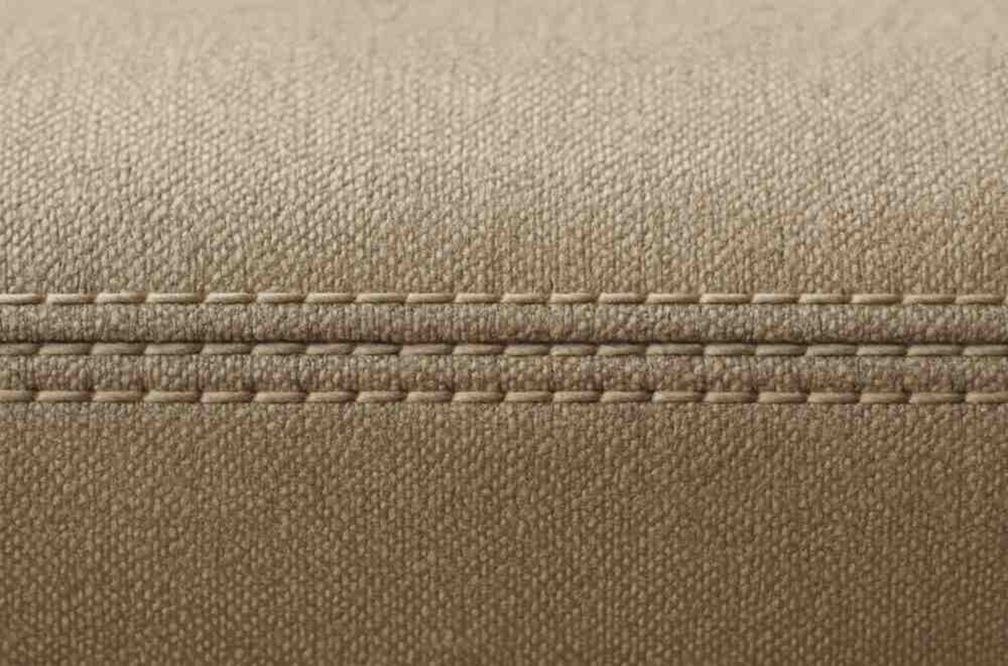 Close-up view of premium double stitching on upholstered fabric, highlighting durability and high-quality craftsmanship
