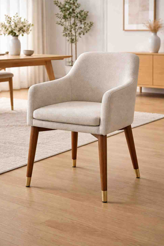 Arm dining chair with curved arms, fabric upholstery, and wooden legs with metal tips