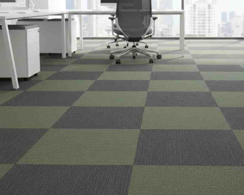 Cut pile carpet tiles in office interior with soft finish and patterned design.