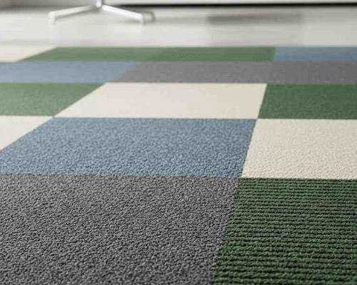 Textured carpet tiles in modern office interior with multi-color square design.