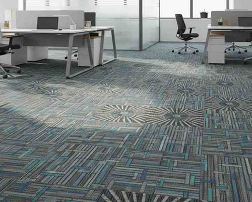 Patterned carpet tiles in modern office space with stylish geometric designs.