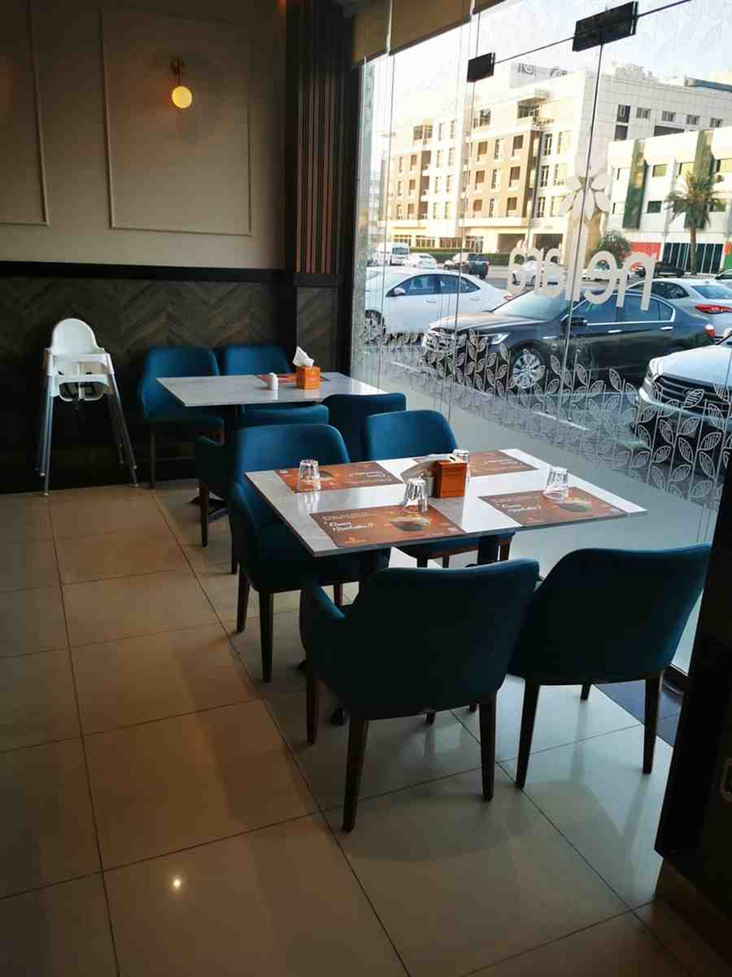 Upholstered dining chairs arranged around tables in modern restaurant interior