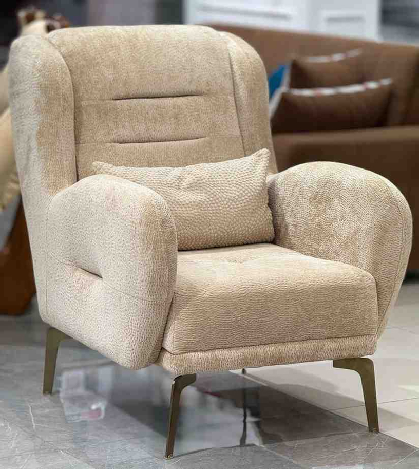 Soft upholstered armchair with padded arms and backrest