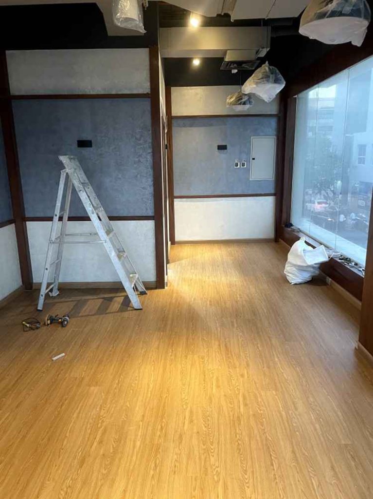 SPC flooring installation in commercial office space with wood finish