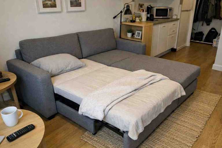 Functional custom made sofa bed converted into sleeping bed for guest accommodation