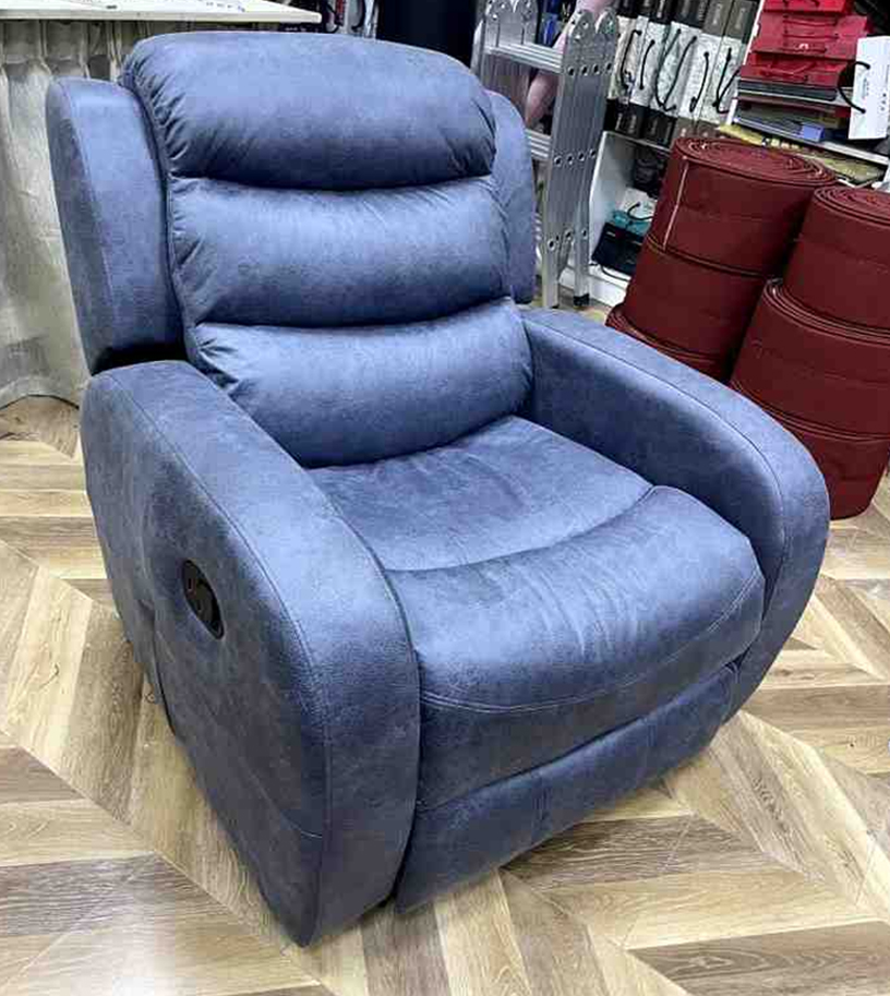 Padded recliner chair with soft fabric upholstery”