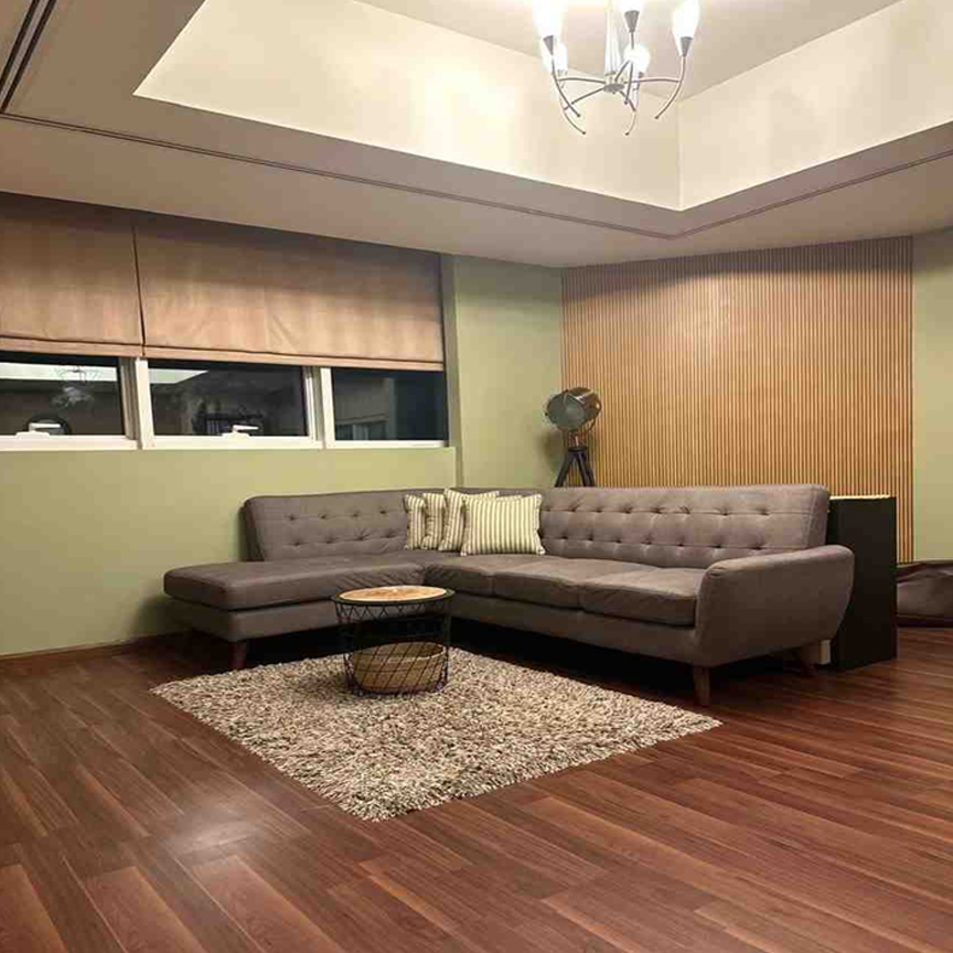 Contemporary custom made L-shaped sofa placed in stylish wooden floor living space