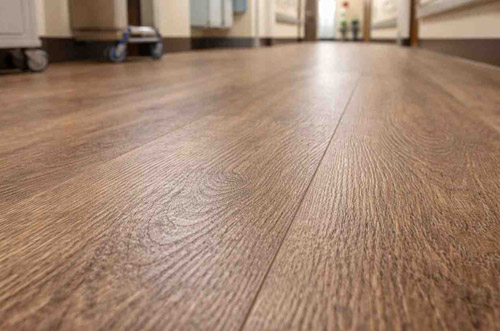 Textured LVT flooring with embossed wood grain surface