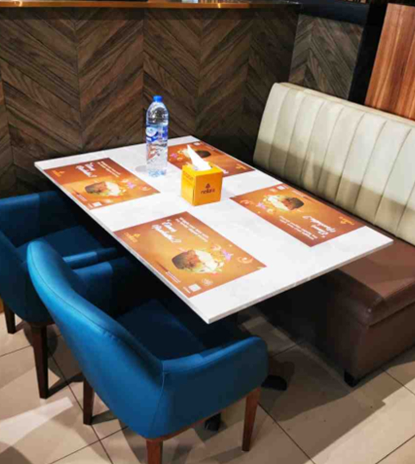Restaurant seating with upholstered chairs and booth bench around a table