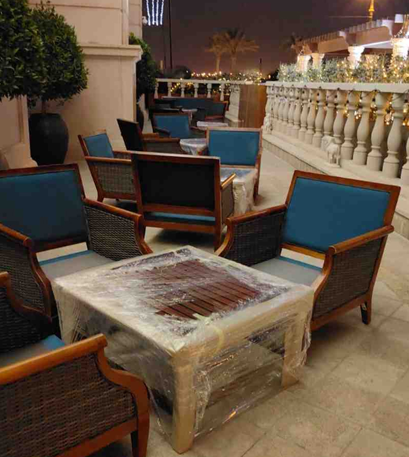 Outdoor seating area with upholstered chairs and a table