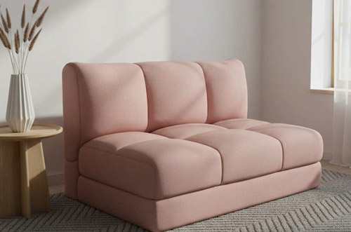 Soft pink foldable sofa bed with cushioned backrest in modern style