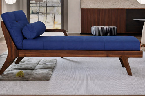 Blue upholstered daybed sofa bed with wooden frame and cylindrical bolster pillow