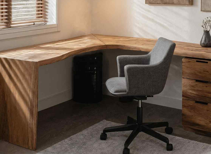 Compact wooden corner desk setup with chair, designed for small office spaces and efficient workspace use