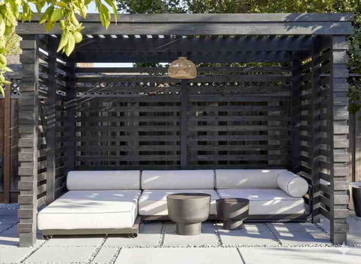 Outdoor cabana seating with built-in wooden structure and cushioned lounge setup