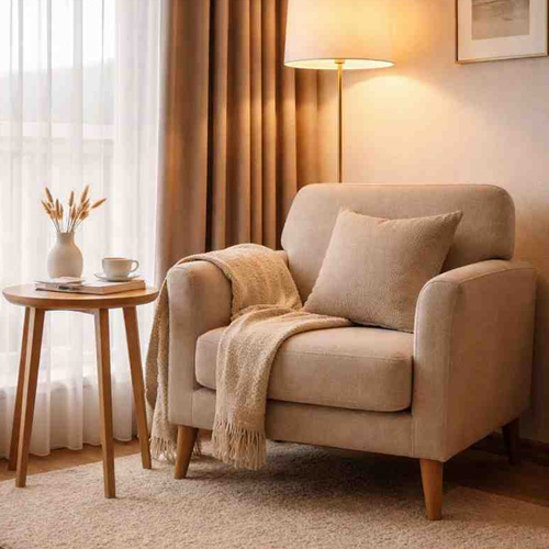 Fabric armchair in guest room with soft upholstery and cozy seating